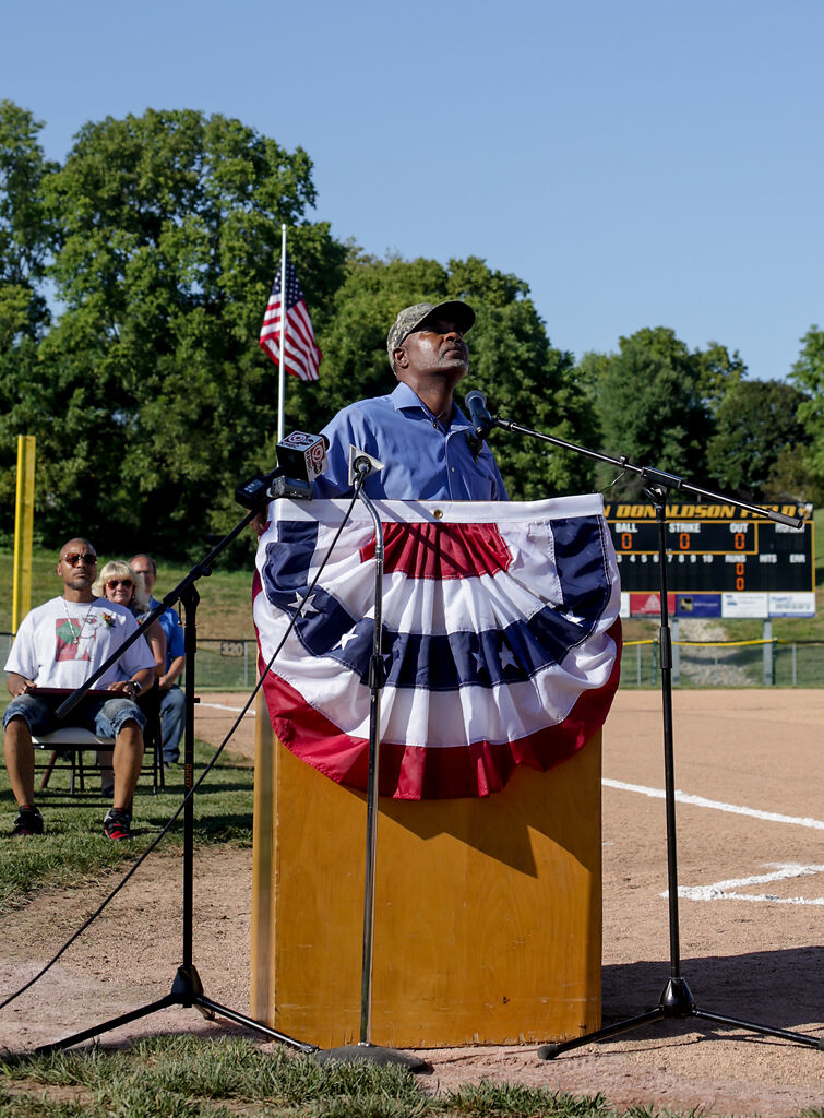 Tommy Herriford looks up at the sky while speaking at the dedication